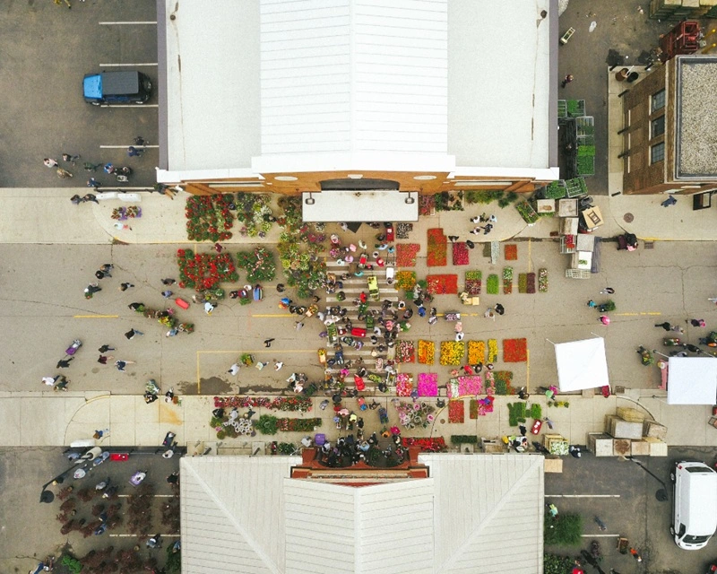 Aerial view of a retail market space with optimised layout, colourful vendor zones, and customer activity