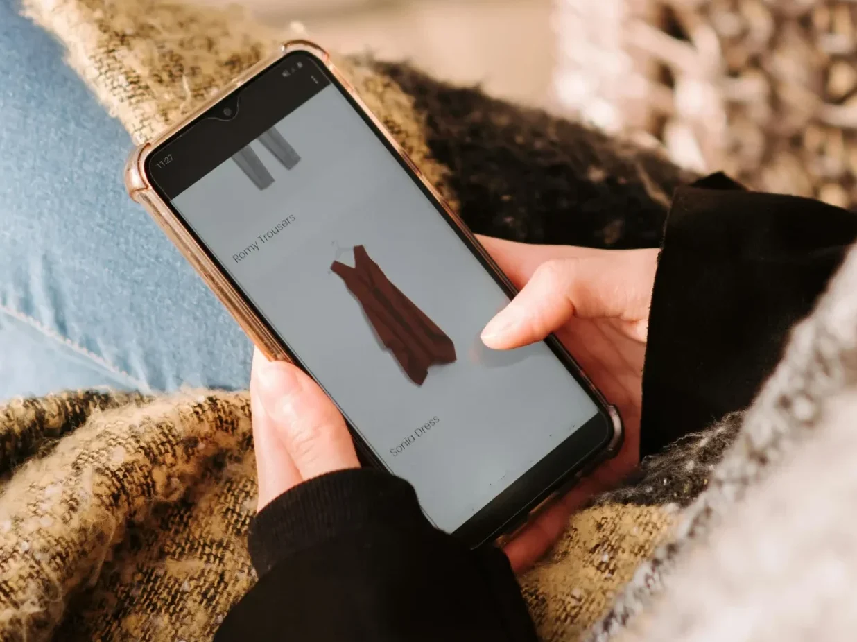 A person using a mobile phone to shop online, representing the rise of AI shopping agents and super apps.